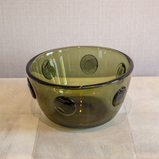 A GREEN GLASS BOWL WITH APPLIED PRUNTZ