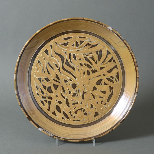 A LARGE BROWN LUSTRE POTTERY CHARGER