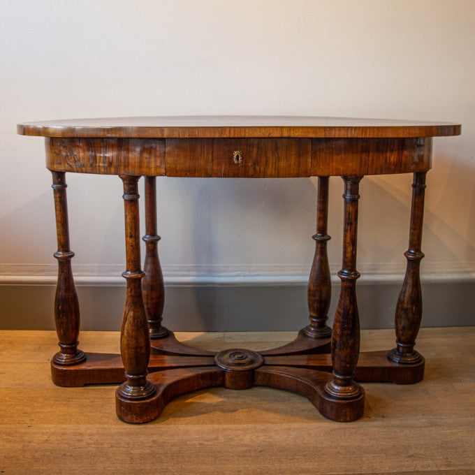 AN OVAL ITALIAN WALNUT CENTRE TABLE
