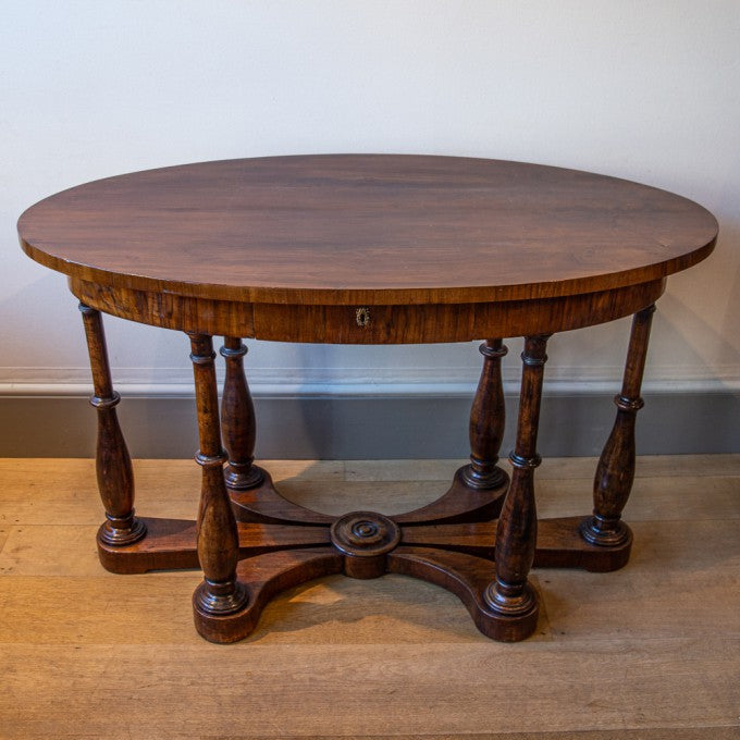 AN OVAL ITALIAN WALNUT CENTRE TABLE
