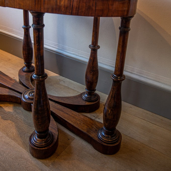 AN OVAL ITALIAN WALNUT CENTRE TABLE