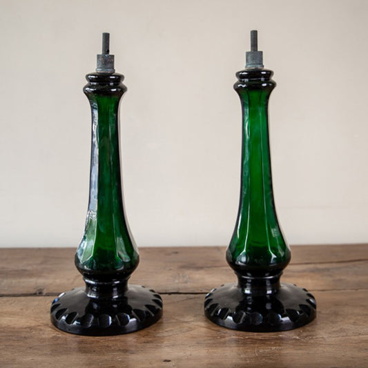A PAIR OF BOTTLE GREEN GLASS BALUSTER LAMPS