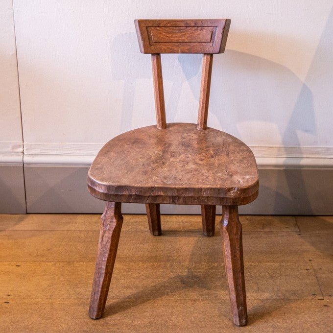 A SMALL LOW SOPHISTICATED RUSTIC CARVED CHAIR BY JACK GRIMBLE