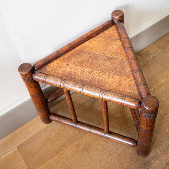 A TRIANGULAR THREE-SQUARE OAK SIDE TABLE