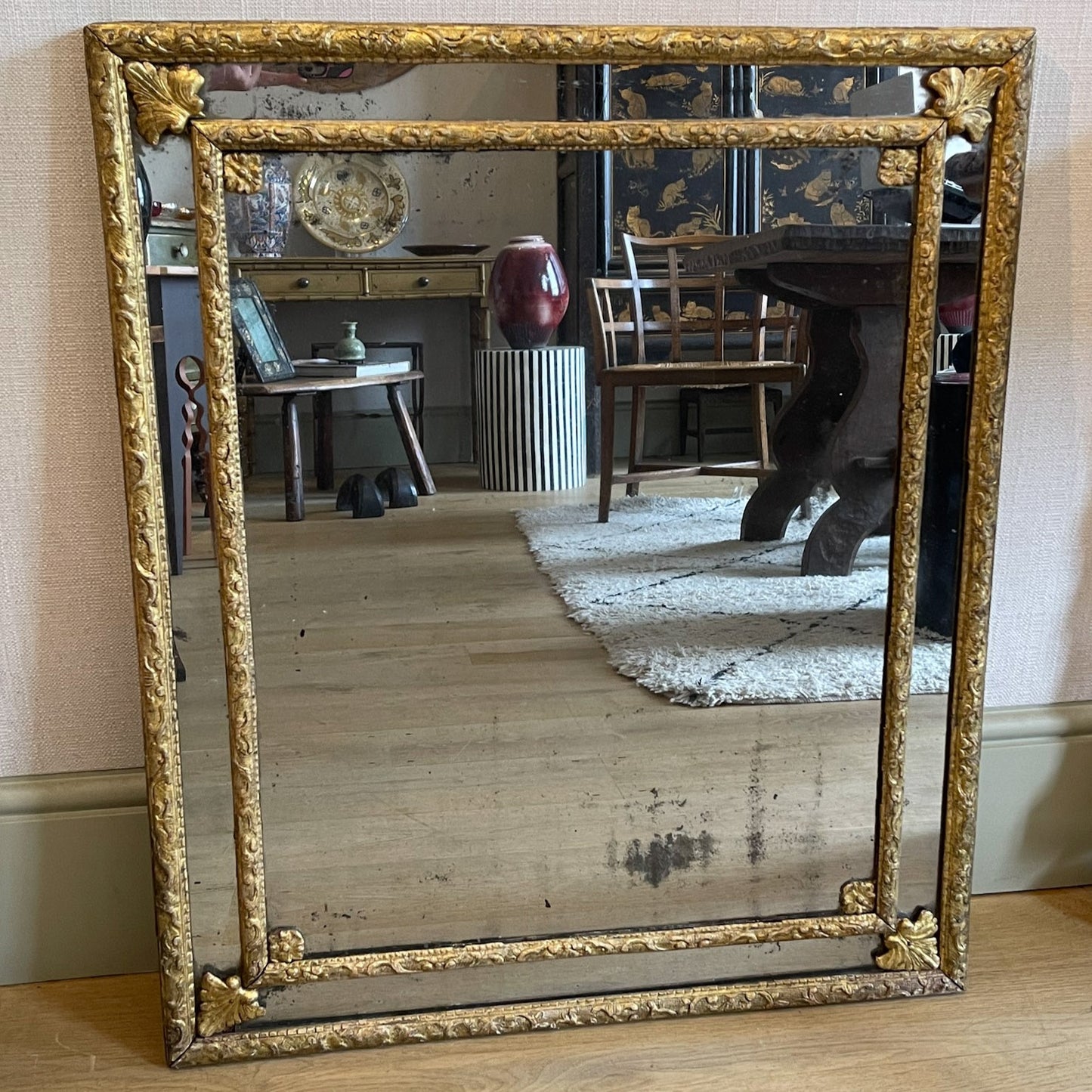 A MIRROR WITH BERAIN FRAME, BORDER PLATES AND FOLIATE CORNERS