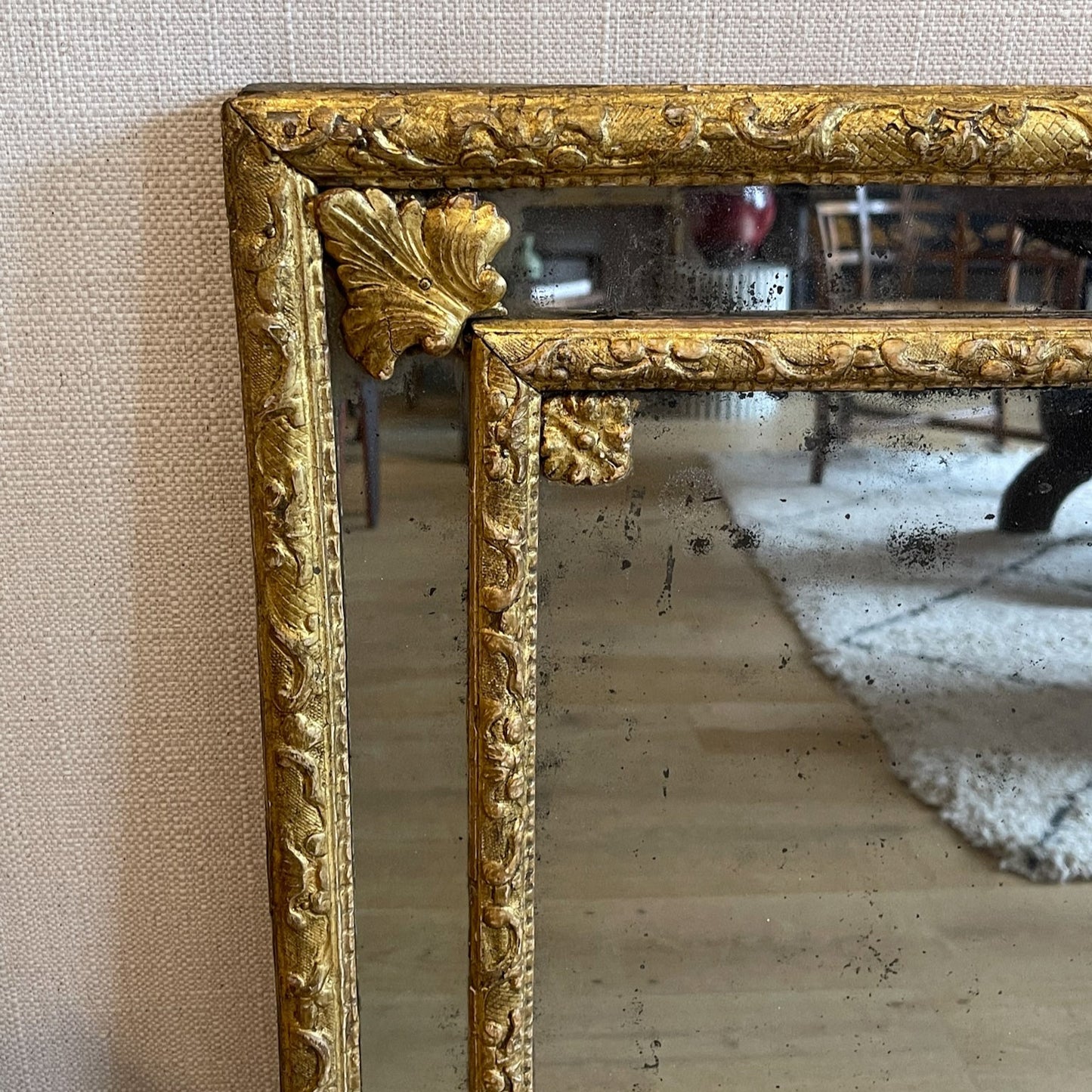 A MIRROR WITH BERAIN FRAME, BORDER PLATES AND FOLIATE CORNERS