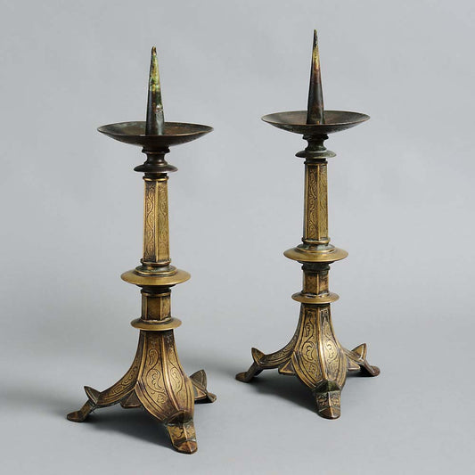 A PAIR OF BRASS PRICKET CANDLESTICKS IN GOTHIC TASTE WITH INCISED DECORATION
