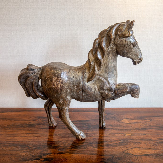 A CARVED FRUITWOOD MODEL OF A HORSE