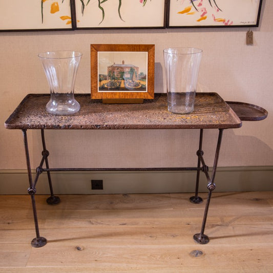 AN INDUSTRIAL WROUGHT IRON TABLE