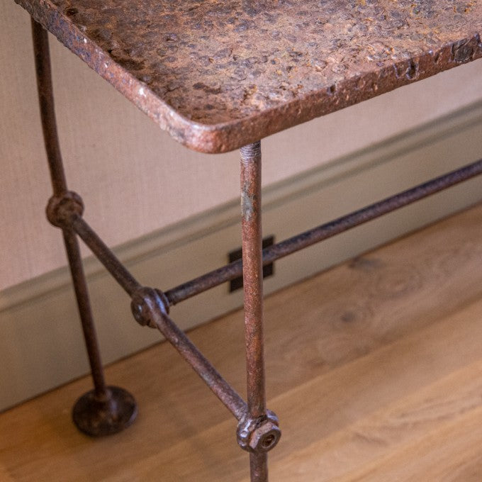 AN INDUSTRIAL WROUGHT IRON TABLE