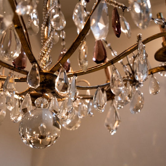 AN ORMOLU AND CUT-GLASS CHANDELIER WITH AMETHYST DROPS BY BAGUES