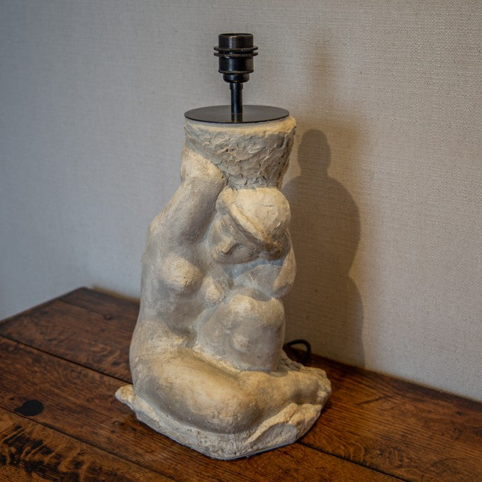 A PLASTER CLASSICAL FIGURE HOLDING A LAMP