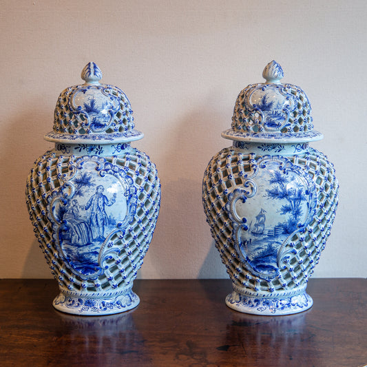 A PAIR OF BLUE AND WHITE DELFT VASES WITH COVERS