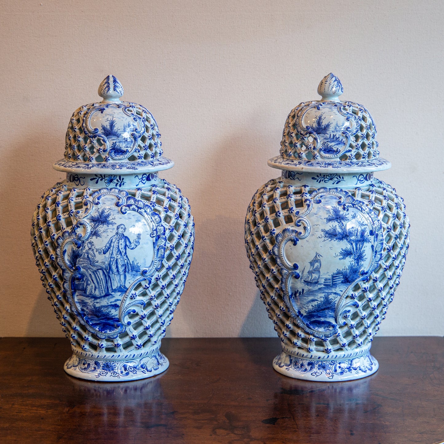 A PAIR OF BLUE AND WHITE DELFT VASES WITH COVERS