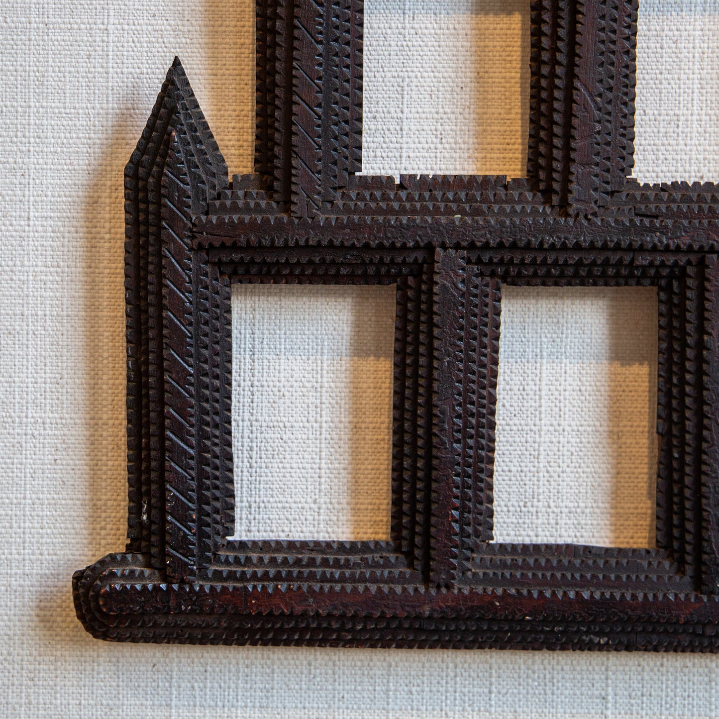A CHIP CARVED PYRAMID SHAPED FRAME