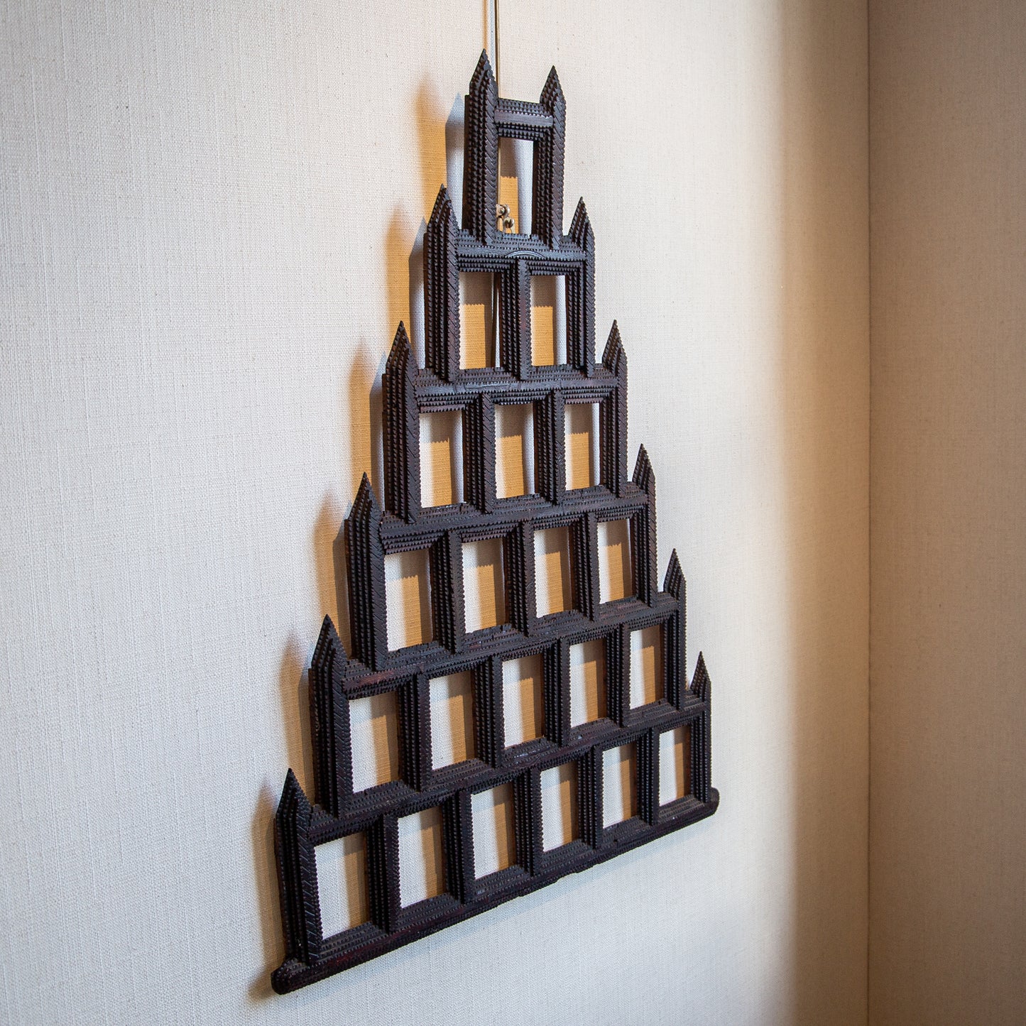 A CHIP CARVED PYRAMID SHAPED FRAME