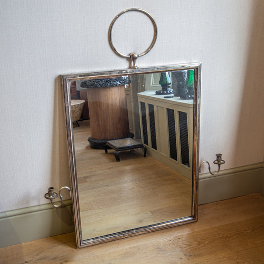 A FINE AND IMPORTANT SILVERED BRASS MIRROR